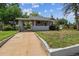Charming home exterior featuring a covered front porch and green lawn at 4001 S Acoma St, Englewood, CO 80110