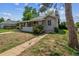 Delightful home exterior featuring a covered porch and manicured front yard at 4001 S Acoma St, Englewood, CO 80110