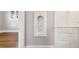 Hallway features a built-in niche, hardwood floors, and built-in cabinets at 4001 S Acoma St, Englewood, CO 80110