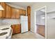 Kitchen featuring wooden cabinets, white countertops, and a white refrigerator at 4001 S Acoma St, Englewood, CO 80110