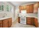 Kitchen featuring wooden cabinets, white countertops, and an older stove at 4001 S Acoma St, Englewood, CO 80110