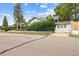 Charming home exterior featuring a detached garage and mature foliage at 4001 S Acoma St, Englewood, CO 80110