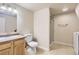 Finished basement bathroom with walk in shower, vanity sink, toilet, and washing machine at 1737 Beeler St, Aurora, CO 80010