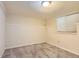 Spare bedroom in a basement with light grey carpet, a light and a small window at 1737 Beeler St, Aurora, CO 80010
