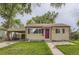 Charming single-story home with a carport, small front lawn, and purple front door at 1737 Beeler St, Aurora, CO 80010