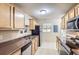 Functional kitchen with wood cabinets, laminate countertops, and modern stainless steel appliances at 1737 Beeler St, Aurora, CO 80010