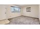 Bright living room features plush gray carpet, neutral walls, and two bright windows at 1737 Beeler St, Aurora, CO 80010