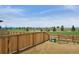 Expansive backyard with wood fence and views of the lush green fields, trees and blue sky at 4113 Marble Dr, Mead, CO 80504