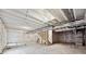 Unfinished basement featuring concrete floor and walls with visible ceiling beams and utilities at 4113 Marble Dr, Mead, CO 80504