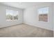 Bright bedroom with neutral carpet and two windows providing ample natural light and views at 4113 Marble Dr, Mead, CO 80504