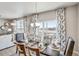 Beautiful dining room with stylish table setting, modern pendant lighting, and views of the surrounding landscape at 4113 Marble Dr, Mead, CO 80504