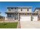 Charming two-story home with a covered porch, stone accents, and a spacious three-car garage at 4113 Marble Dr, Mead, CO 80504