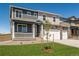 Beautiful two-story home boasts a cozy front porch and an attached three-car garage at 4113 Marble Dr, Mead, CO 80504