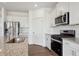 Close-up of kitchen showcasing stainless steel appliances, granite countertops, and subway tile backsplash at 4113 Marble Dr, Mead, CO 80504