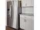 Stainless steel refrigerator with water dispenser and granite countertops with white cabinets at 4113 Marble Dr, Mead, CO 80504