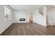 Bright living room with hardwood floors and electric fireplace at 4113 Marble Dr, Mead, CO 80504