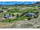 A spacious home with a metal barn-like structure sits on green, open land under a partly cloudy sky at 4781 Mariposa Rd, Castle Rock, CO 80104