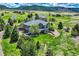 An aerial view showcasing a beautiful home surrounded by lush greenery and mature trees at 4781 Mariposa Rd, Castle Rock, CO 80104