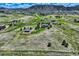 Picturesque aerial view of a sprawling property with homes nestled in a verdant landscape at 4781 Mariposa Rd, Castle Rock, CO 80104