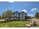 Beautiful backyard featuring a large lawn, rock features, patio, and hot tub, perfect for outdoor living at 4781 Mariposa Rd, Castle Rock, CO 80104