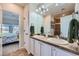Bathroom with a double sink vanity and tiled floor, conveniently located near the bedroom for easy access at 4781 Mariposa Rd, Castle Rock, CO 80104