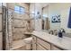 Well-lit bathroom featuring granite counters, tiled shower, and modern fixtures at 4781 Mariposa Rd, Castle Rock, CO 80104