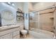 Well-lit bathroom featuring a tiled shower, glass door and a vanity with a decorative mirror, ideal for relaxation at 4781 Mariposa Rd, Castle Rock, CO 80104