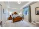 Cozy bedroom with wood-frame bed, complemented by soft lighting and neutral tones, offering a restful ambiance at 4781 Mariposa Rd, Castle Rock, CO 80104