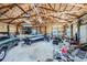 Large garage with a boat and a truck with high ceilings and exposed rafters offering plenty of storage space at 4781 Mariposa Rd, Castle Rock, CO 80104