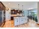 Modern kitchen featuring a large island, custom cabinetry, stainless steel appliances, and an eat-in area at 4781 Mariposa Rd, Castle Rock, CO 80104