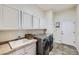 Well-equipped laundry room with ample cabinet space, a sink, and modern washer and dryer units, providing convenience at 4781 Mariposa Rd, Castle Rock, CO 80104