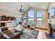 Bright open living area with high ceilings, a fireplace, and a stunning view from oversized windows at 4781 Mariposa Rd, Castle Rock, CO 80104