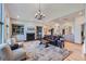 Comfortable living room with a fireplace, built-in shelving, and a view into the entry and dining area at 4781 Mariposa Rd, Castle Rock, CO 80104