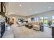 Open-concept living room with plush seating, fireplace, and sliding glass doors to outdoor area, great for entertaining at 4781 Mariposa Rd, Castle Rock, CO 80104