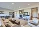Spacious living room featuring a stone fireplace, large sectional sofa, and a bar area for entertaining guests at 4781 Mariposa Rd, Castle Rock, CO 80104