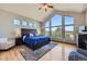 Spacious bedroom boasts abundant natural light from large windows with scenic views and a ceiling fan at 4781 Mariposa Rd, Castle Rock, CO 80104