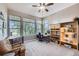 Bright home office with many windows offering scenic views, built-in shelving, and ceiling fan at 4781 Mariposa Rd, Castle Rock, CO 80104