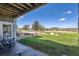 Covered patio with seating area overlooking the expansive yard and scenic views at 4781 Mariposa Rd, Castle Rock, CO 80104