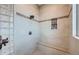 Tiled shower featuring a built-in bench and a mosaic tile accent, with glass block window at 4781 Mariposa Rd, Castle Rock, CO 80104