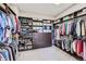 Organized walk-in closet featuring built-in shelving, drawers, and ample hanging space for storage at 4781 Mariposa Rd, Castle Rock, CO 80104