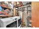 Well-organized basement area with modern washer and dryer, storage shelves, and utility connections at 5323 E Sandpiper Ave, Castle Rock, CO 80104