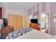 Bedroom with striped walls, closet space, adjacent bathroom, and work area at 5323 E Sandpiper Ave, Castle Rock, CO 80104