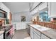 Efficient kitchen setup with white cabinets, stainless steel appliances, and a view to the upper level at 5323 E Sandpiper Ave, Castle Rock, CO 80104
