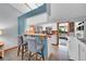 Charming kitchen with barstool seating, white cabinets, and an open view to the living room at 5323 E Sandpiper Ave, Castle Rock, CO 80104
