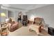 Cozy living room with comfortable seating, including recliners and a massage chair, under soft lighting at 5323 E Sandpiper Ave, Castle Rock, CO 80104