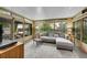 Bright sunroom featuring large windows, a comfortable seating area, and access to the outdoors at 5323 E Sandpiper Ave, Castle Rock, CO 80104