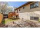 Exterior of the home showcasing a backyard with a wooden deck, lawn, and beige siding at 778 2Nd St, Firestone, CO 80520