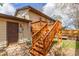 Exterior view of backyard featuring a wooden deck with stairs and a beige siding home at 778 2Nd St, Firestone, CO 80520