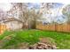 Large fenced backyard with a mix of grass and foliage, providing a private outdoor space at 778 2Nd St, Firestone, CO 80520