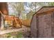 Fenced backyard with deck, stairs, and storage shed at 778 2Nd St, Firestone, CO 80520